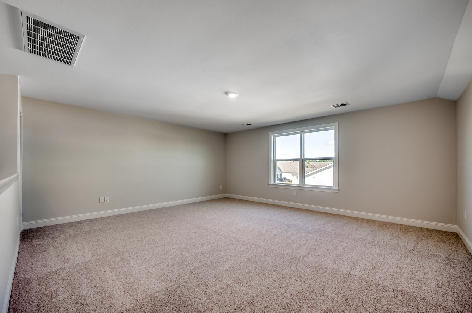 spacious upstairs area with light gray walls and carpeting throughout