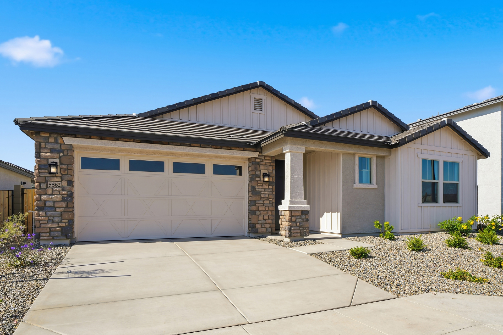 single-story single-family home with desert landscaping and concrete driveway