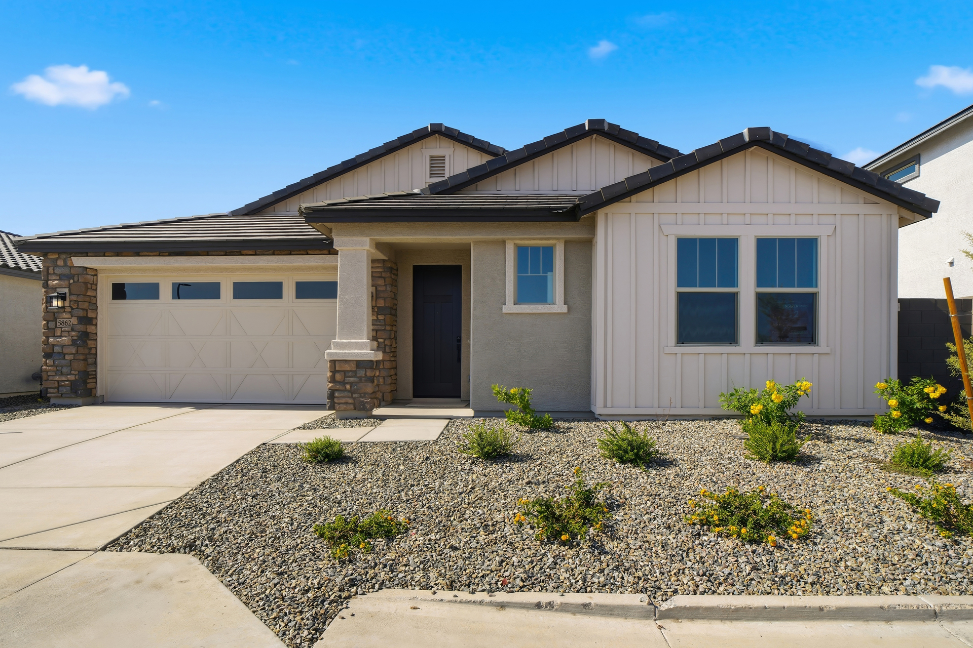 single-story single-family home with desert landscaping and concrete driveway