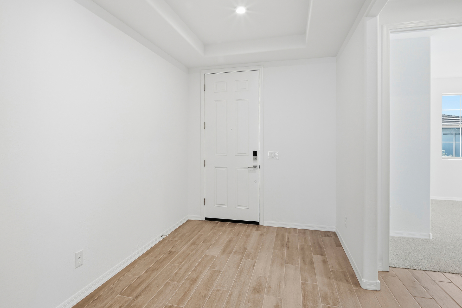 open-concept foyer with wood-like tile flooring throughout