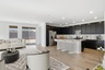 open-concept space with wood-like flooring, white accent chairs, and beige rug