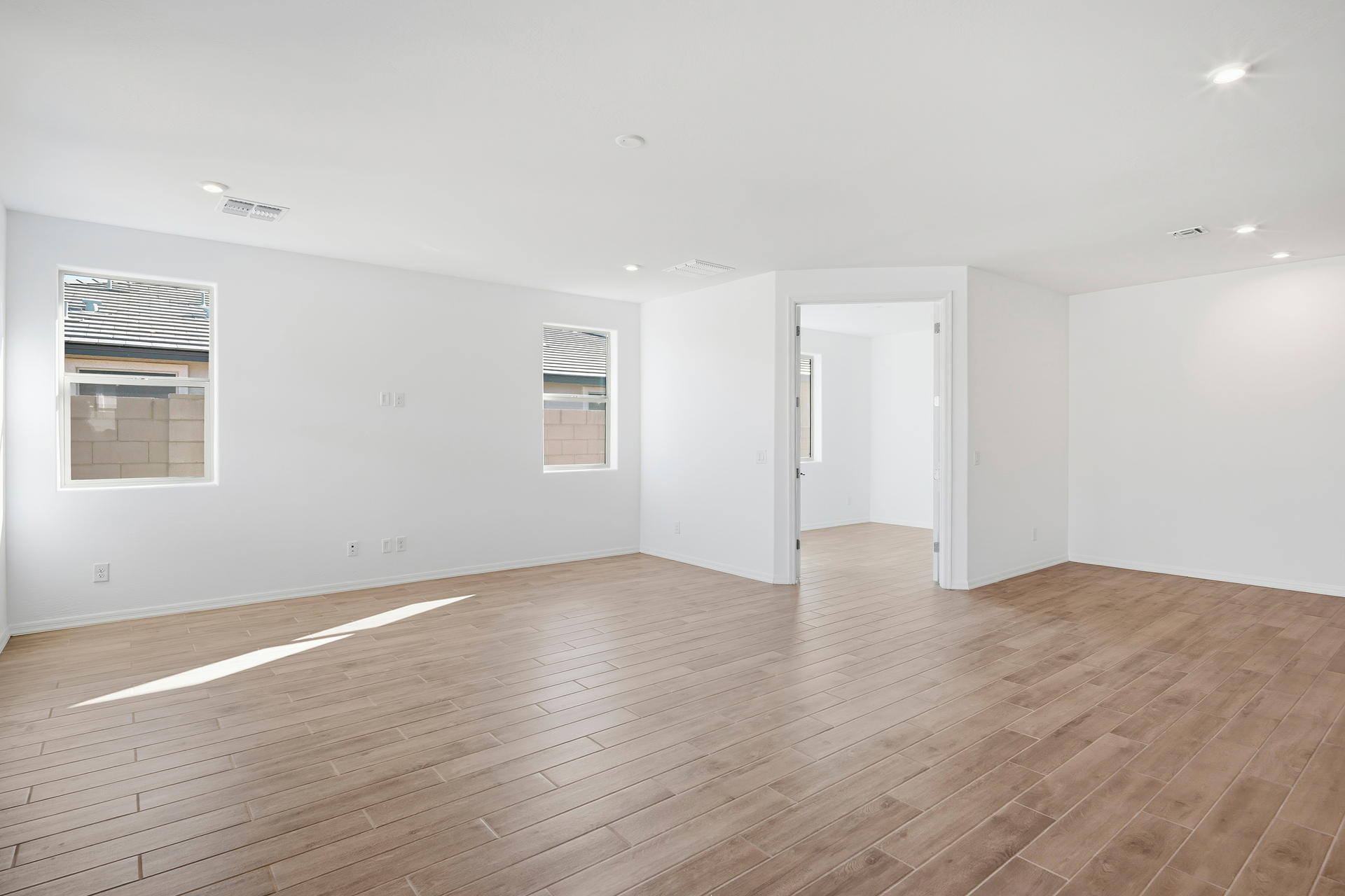open-concept space with wood-like tile flooring and access to the backyard patio