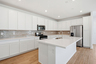 kitchen with white cabinets, quartz countertops, and stainless-steel appliances