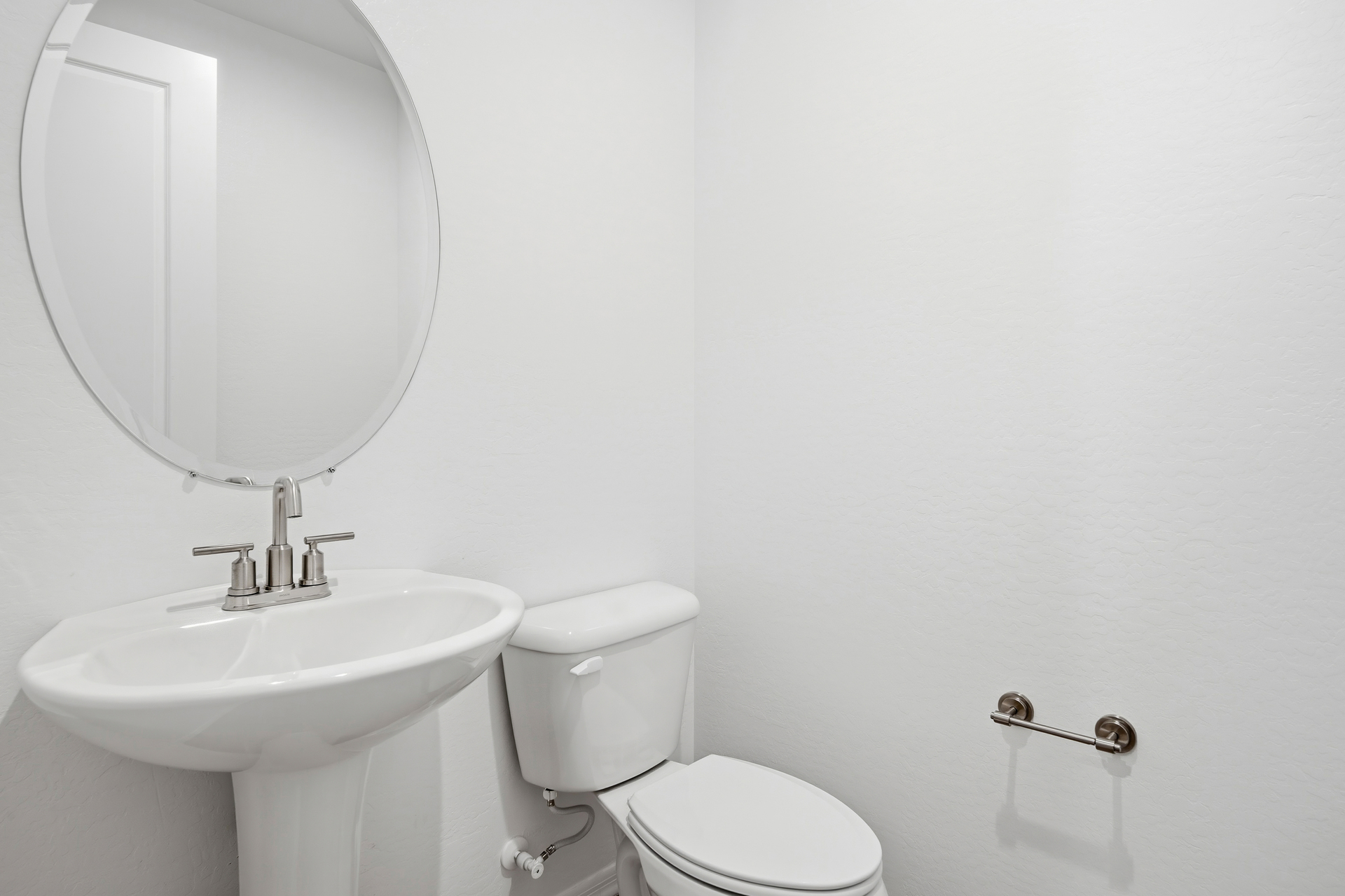 powder room with pedestal sink and brushed nickel faucet