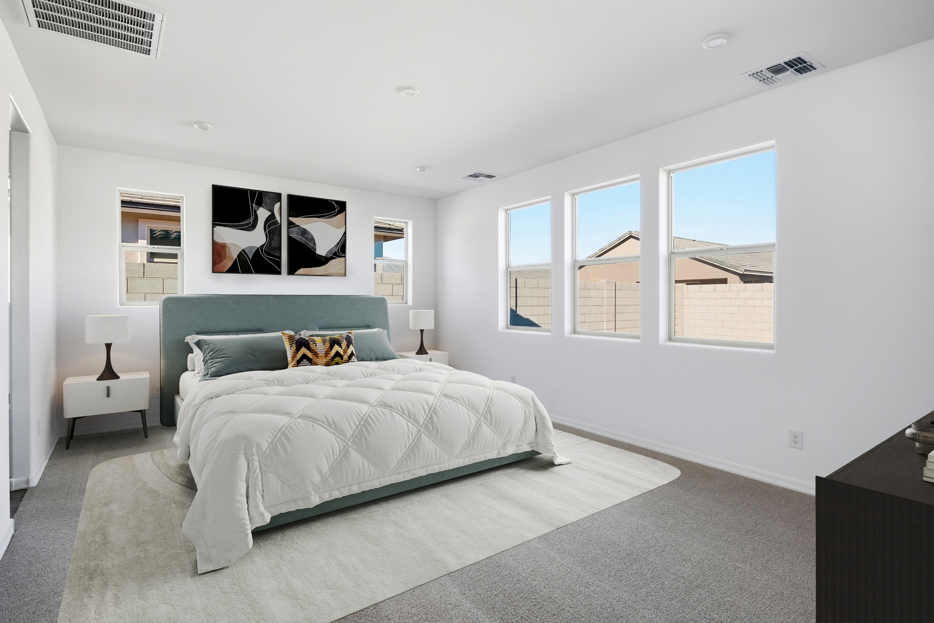 spacious bedroom with large bed and white nightstands