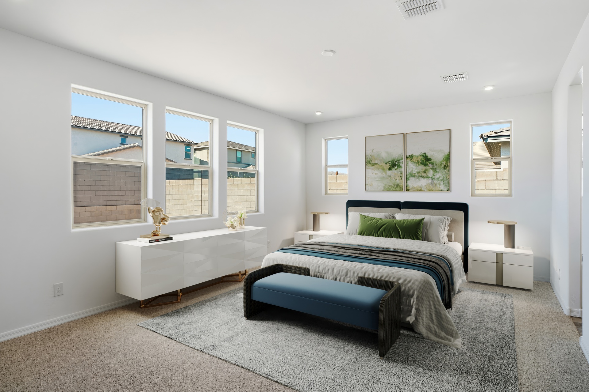 spacious bedroom with a king-sized bed, teal bed bench, and modern white nightstands