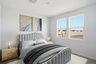 teal bed and bedframe with oak nightstands