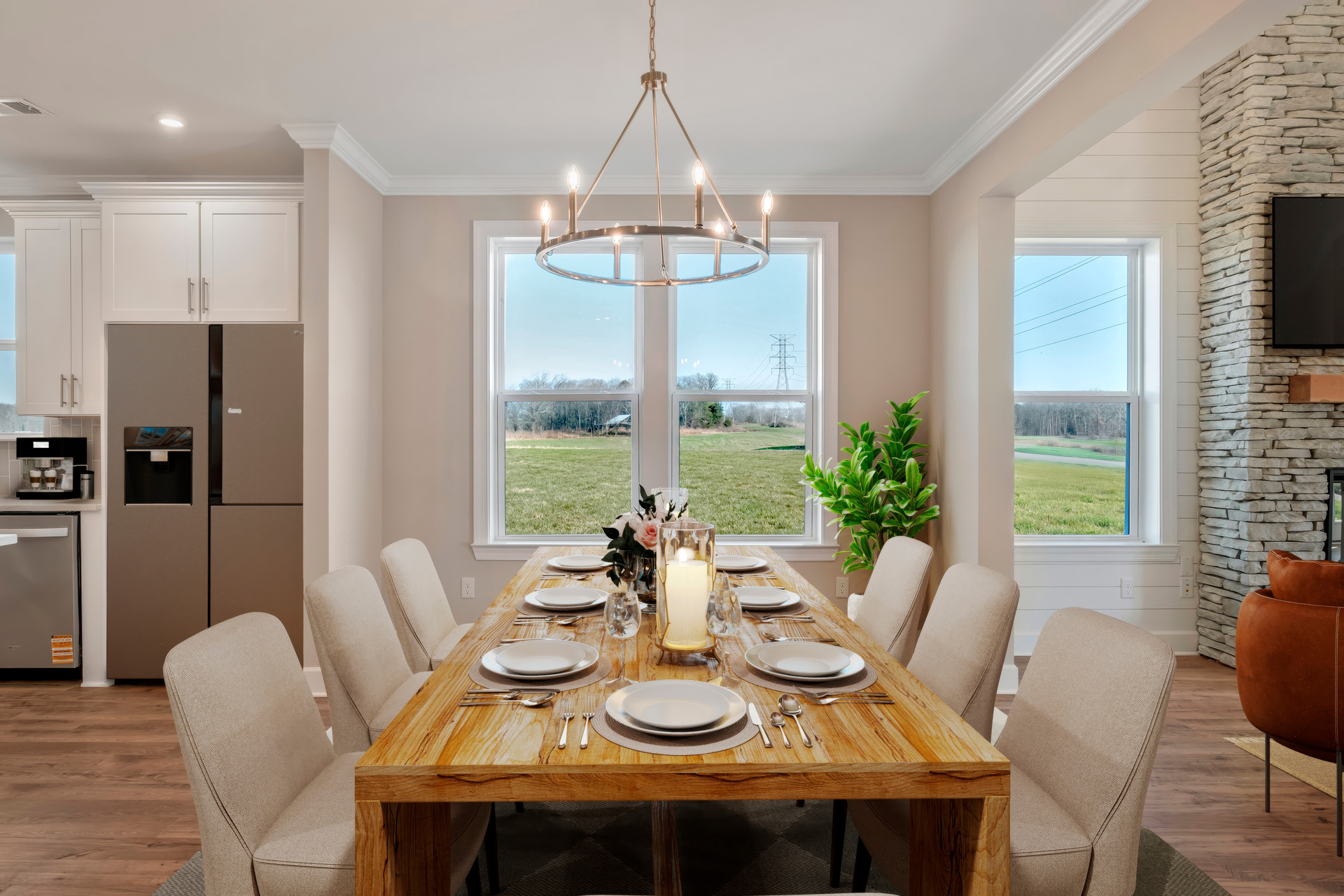 dining room with wood flooring, large windows and a table and chairs