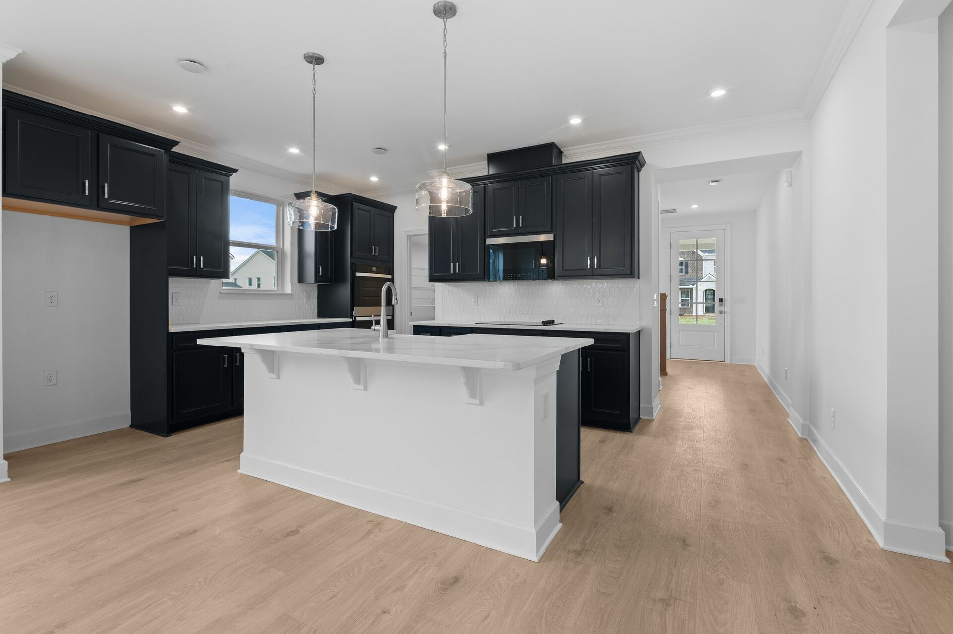 kitchen with wood flooring, navy cabinets and white countertops