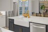 kitchen with blue cabinets, farmhouse sink, and gold hardware