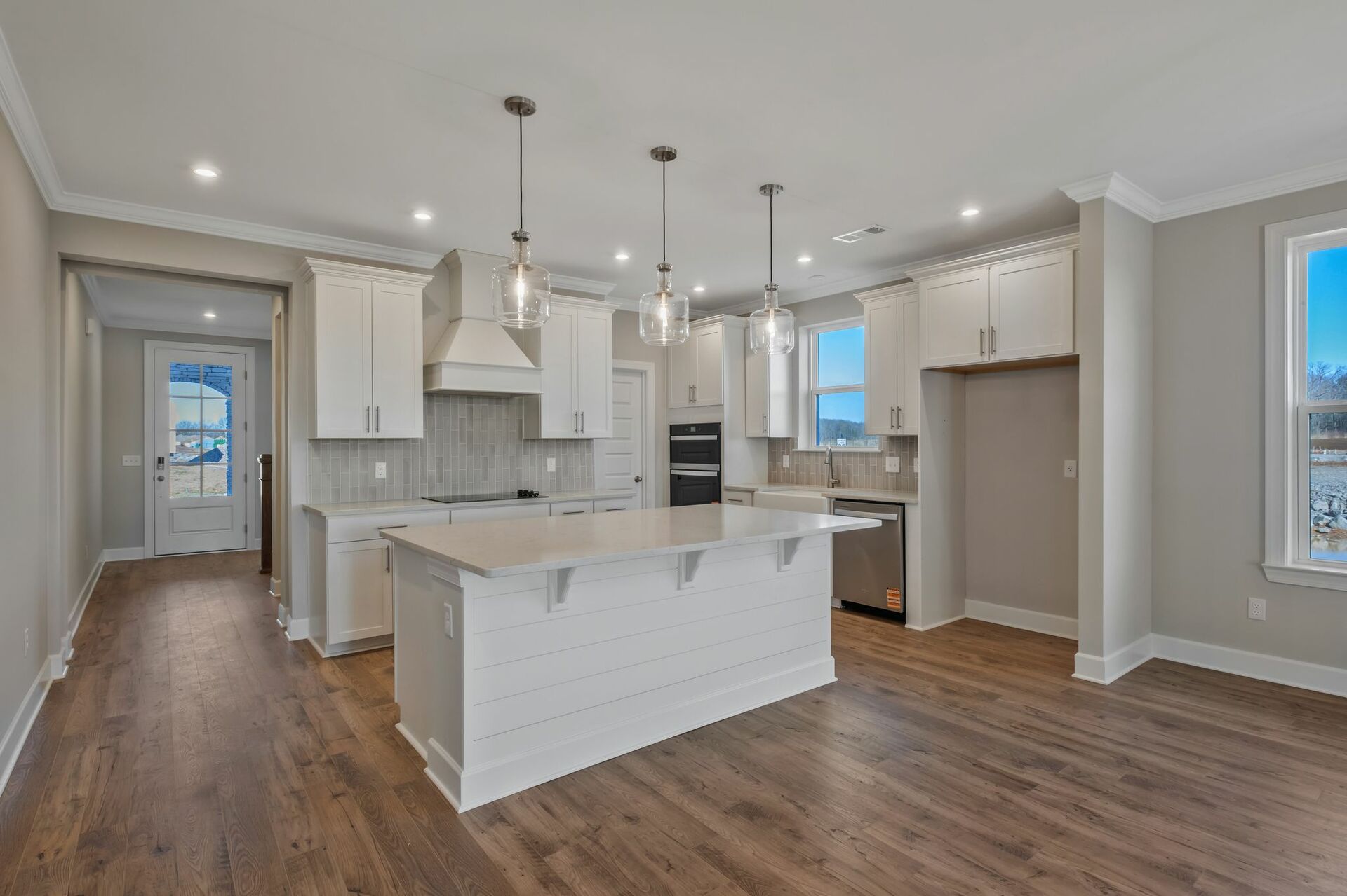 kitchen with wood flooring, white cabinets, and white countertops