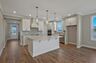 kitchen with wood flooring, white cabinets, and white countertops