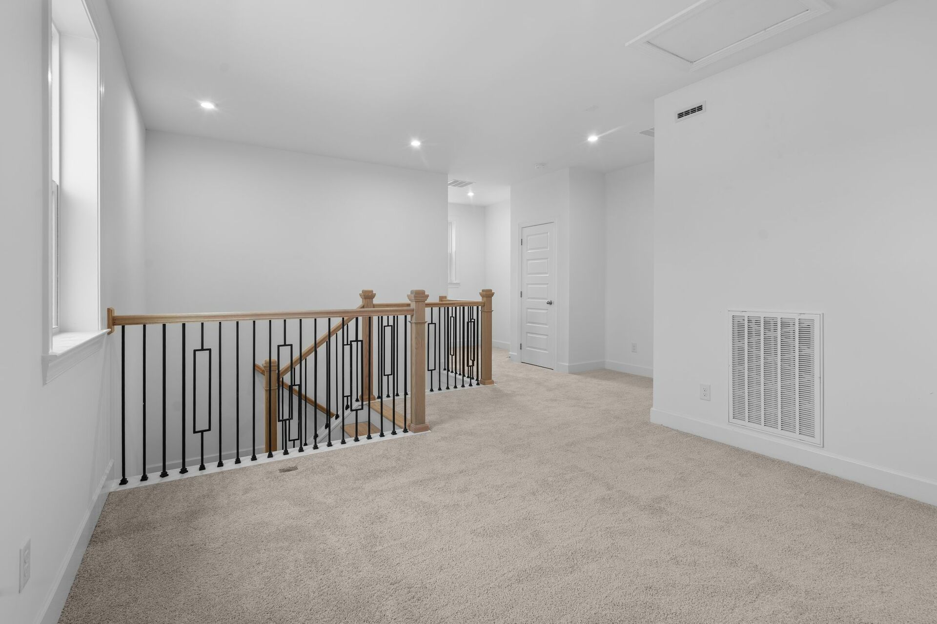 loft space with carpet flooring, white trip, and open space