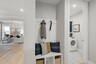 valet bench with hooks for storage by laundryroom