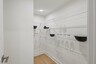 large walk-in pantry with built in wire shelves