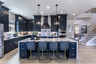 kitchen with dark cabinets and quartz counters