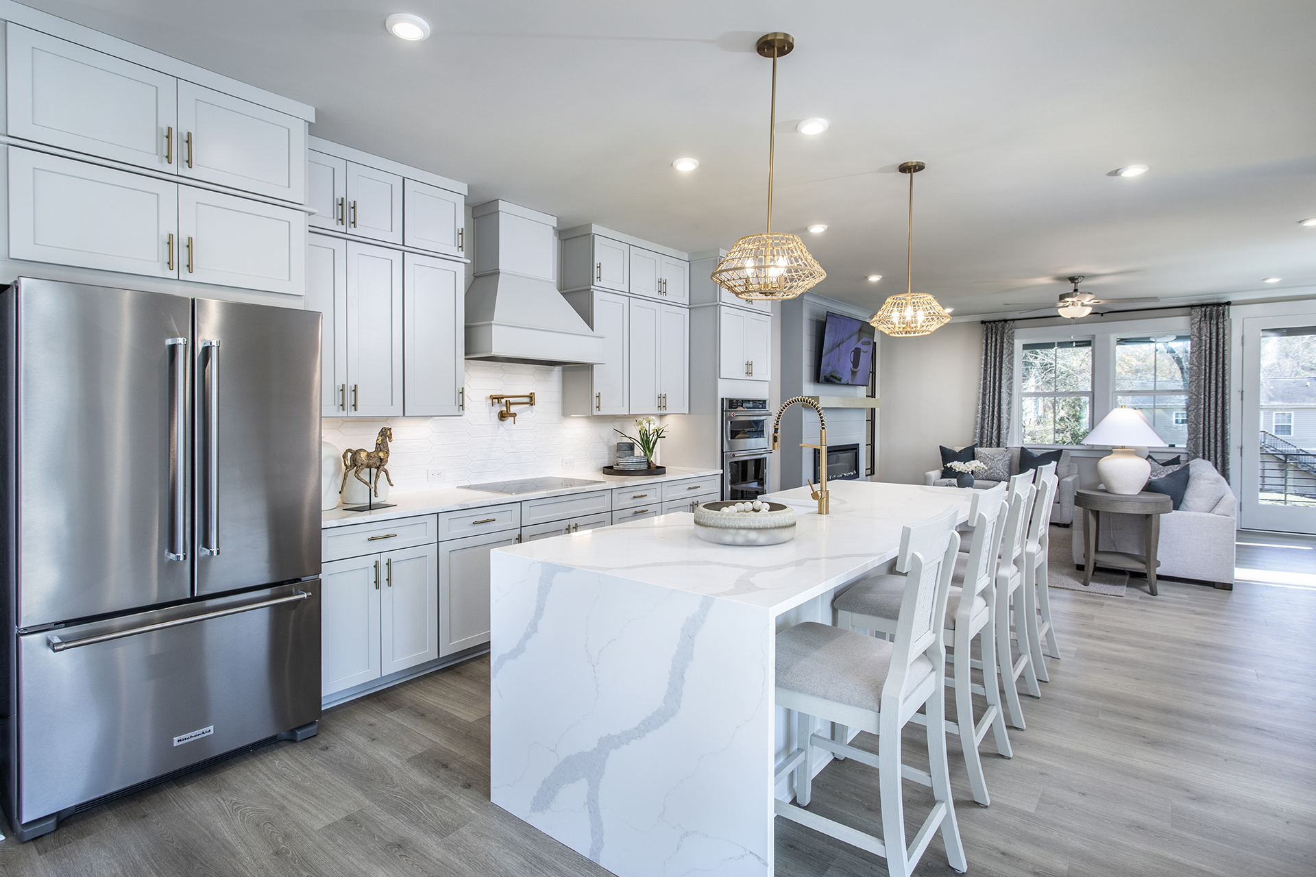 kitchen with waterfall quartz island and white cabinets