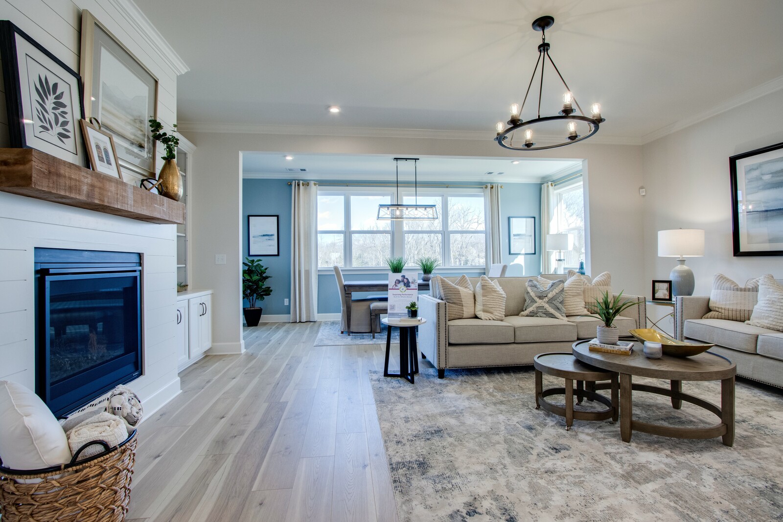 great room with sofas, fireplace, and dining area