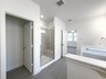primary bathroom with separate walk-in shower and soaking tub