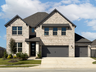 exterior of home with tan brick and stone