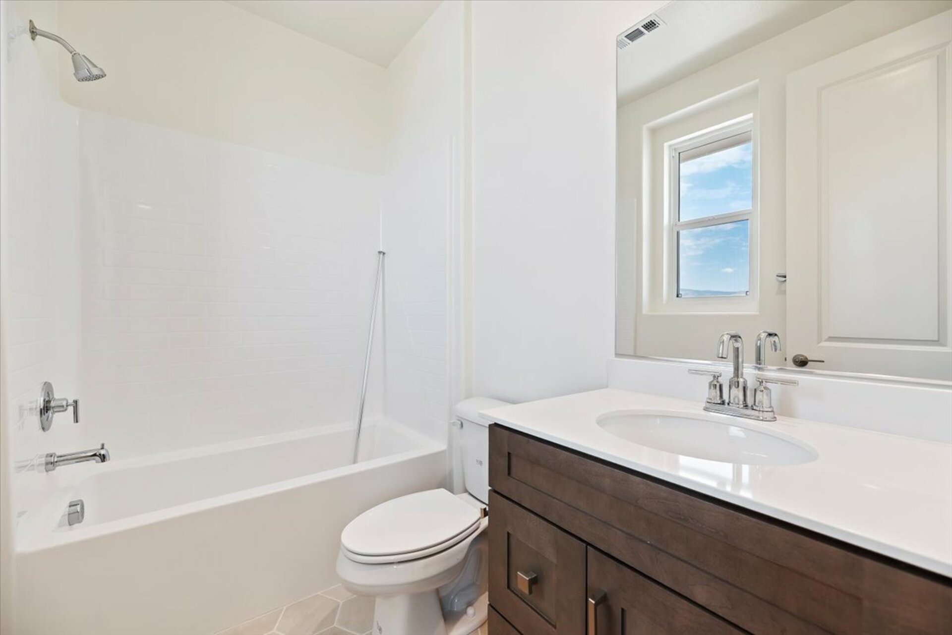 bathroom with shower and white countertops