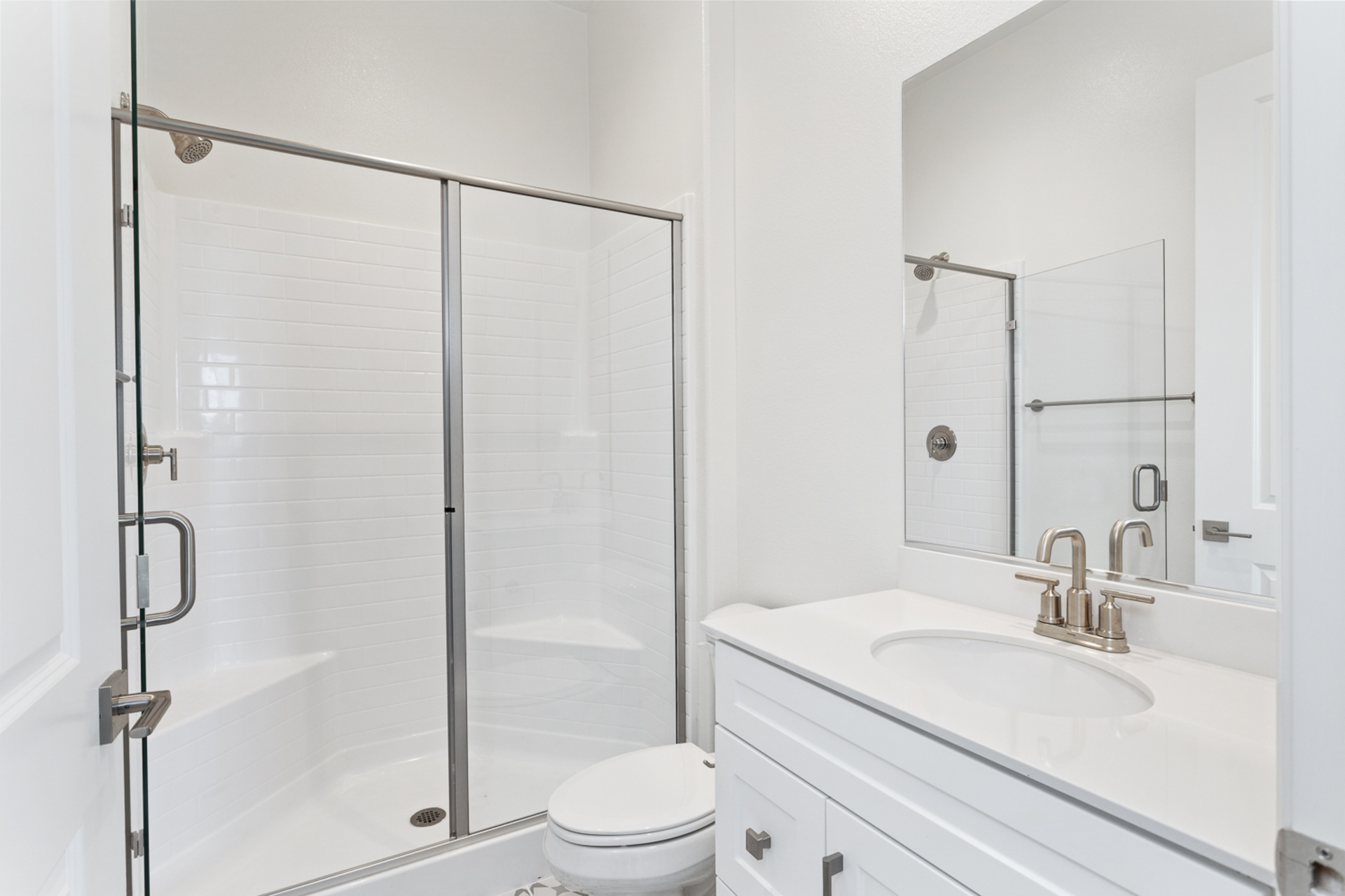 bathroom with white cabinets and countertops