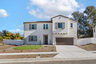 exterior of two-story single-family home with front yard landscaping and brown garage