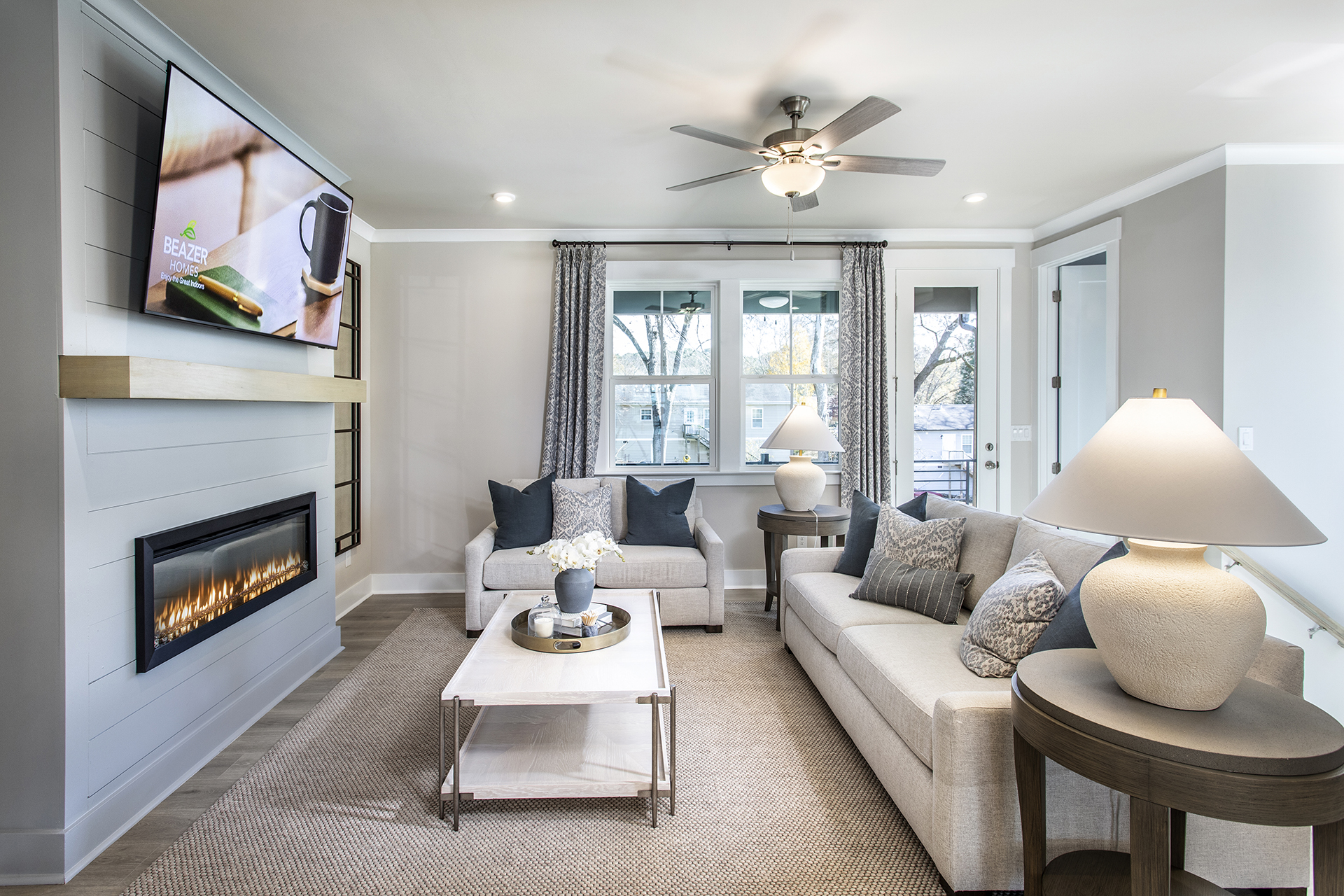great room with electric fireplace and light flooring