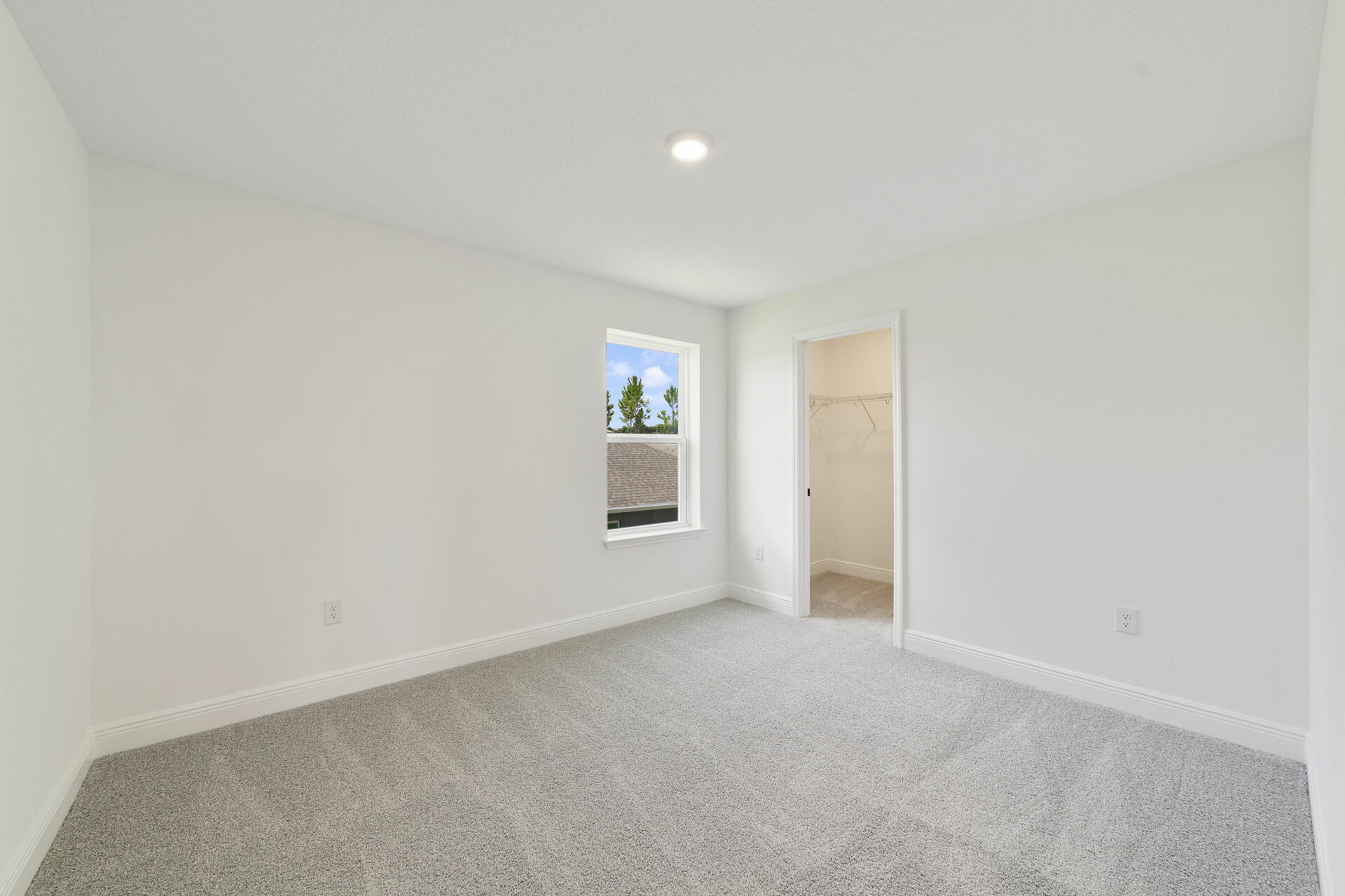 carpet throughout with a single window and access to the closet