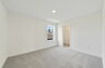 carpet throughout with a single window and access to the closet