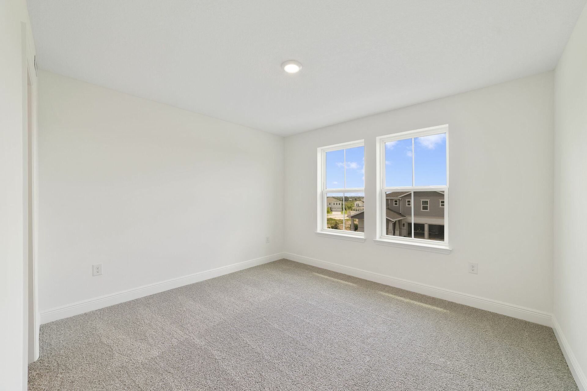 carpet throughout with multiple windows