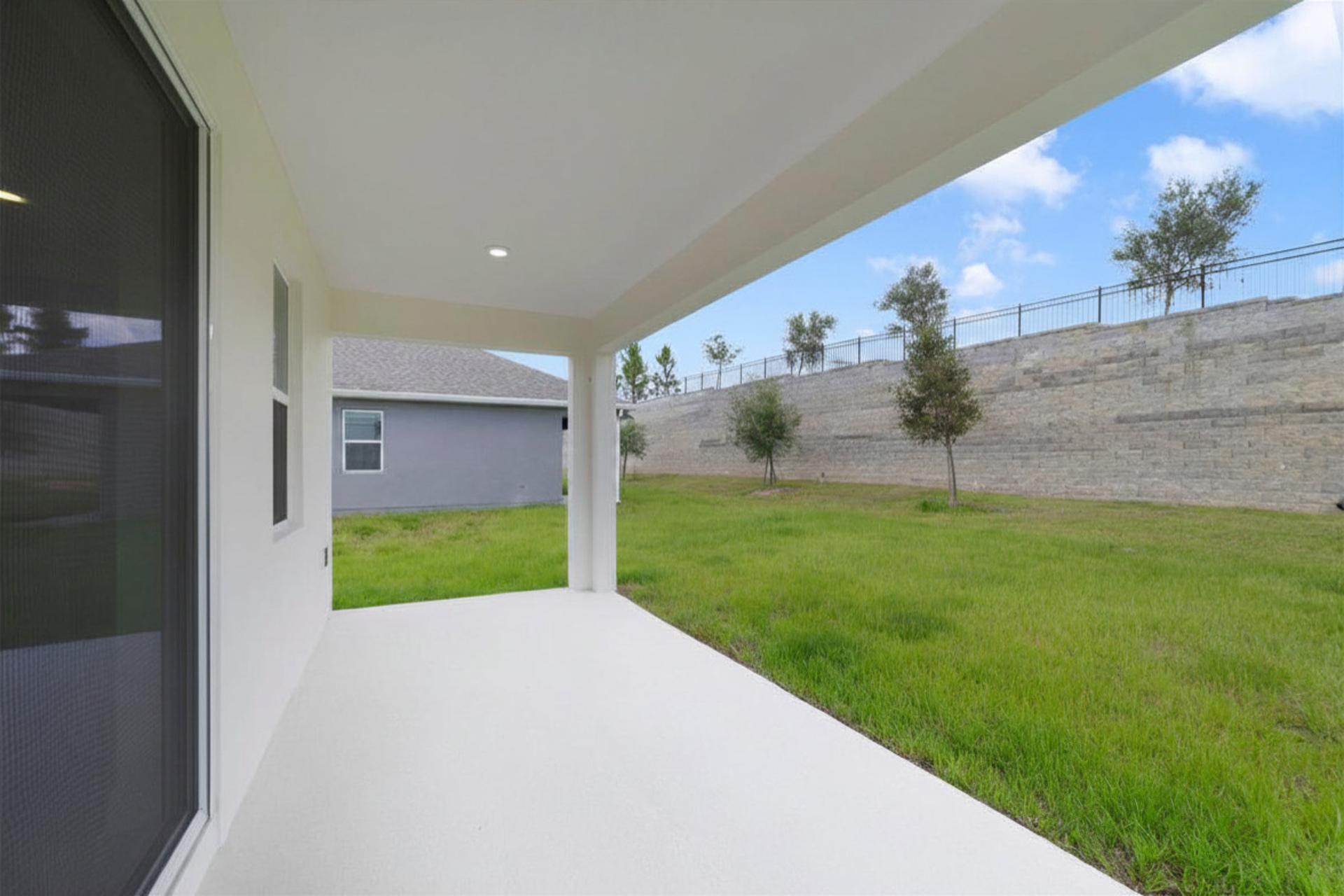 covered patio and backyard