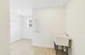room with oversized sink, single window and storage racks