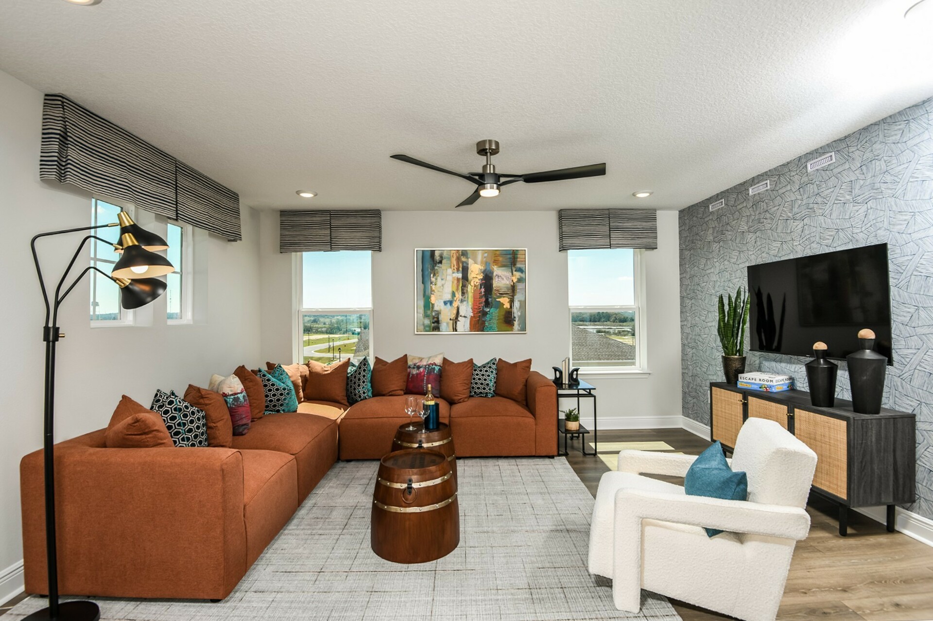 loft with orange sectional and white accent chair