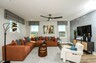 loft with orange sectional and white accent chair