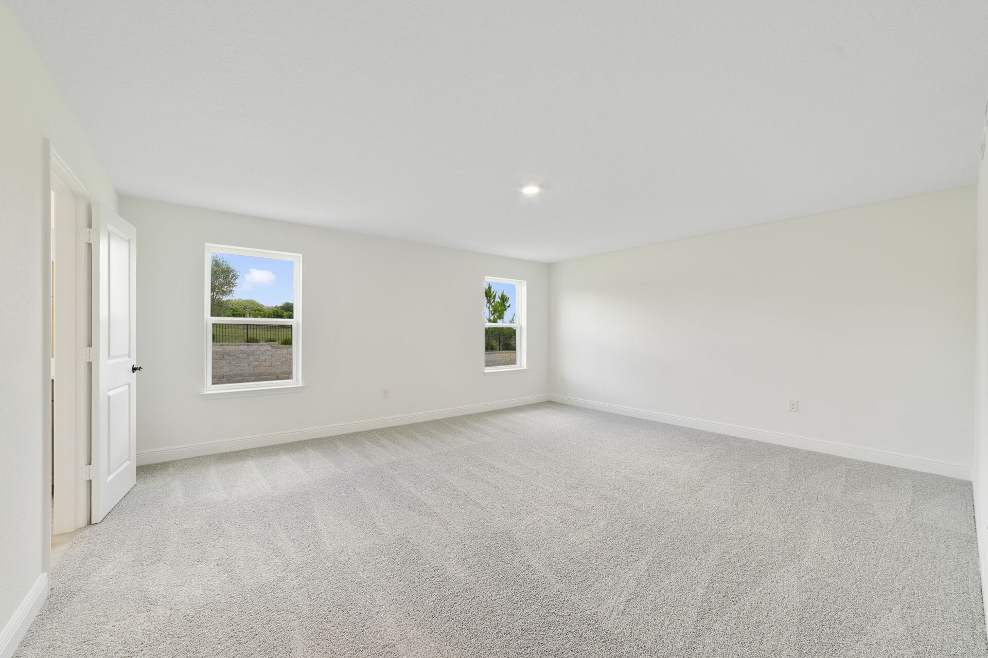 carpet throughout with multiple windows and access to the primary bathroom