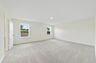 carpet throughout with multiple windows and access to the primary bathroom