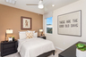 bedroom with neutral flooring and large window
