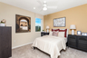 bedroom with neutral carpet and accent wall