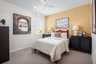 bedroom with neutral carpet and accent walls