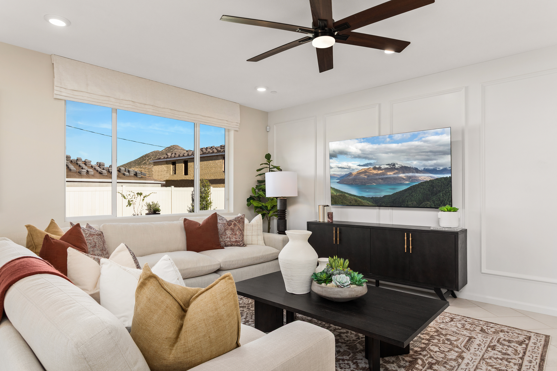 great room with neutral floors and large windows