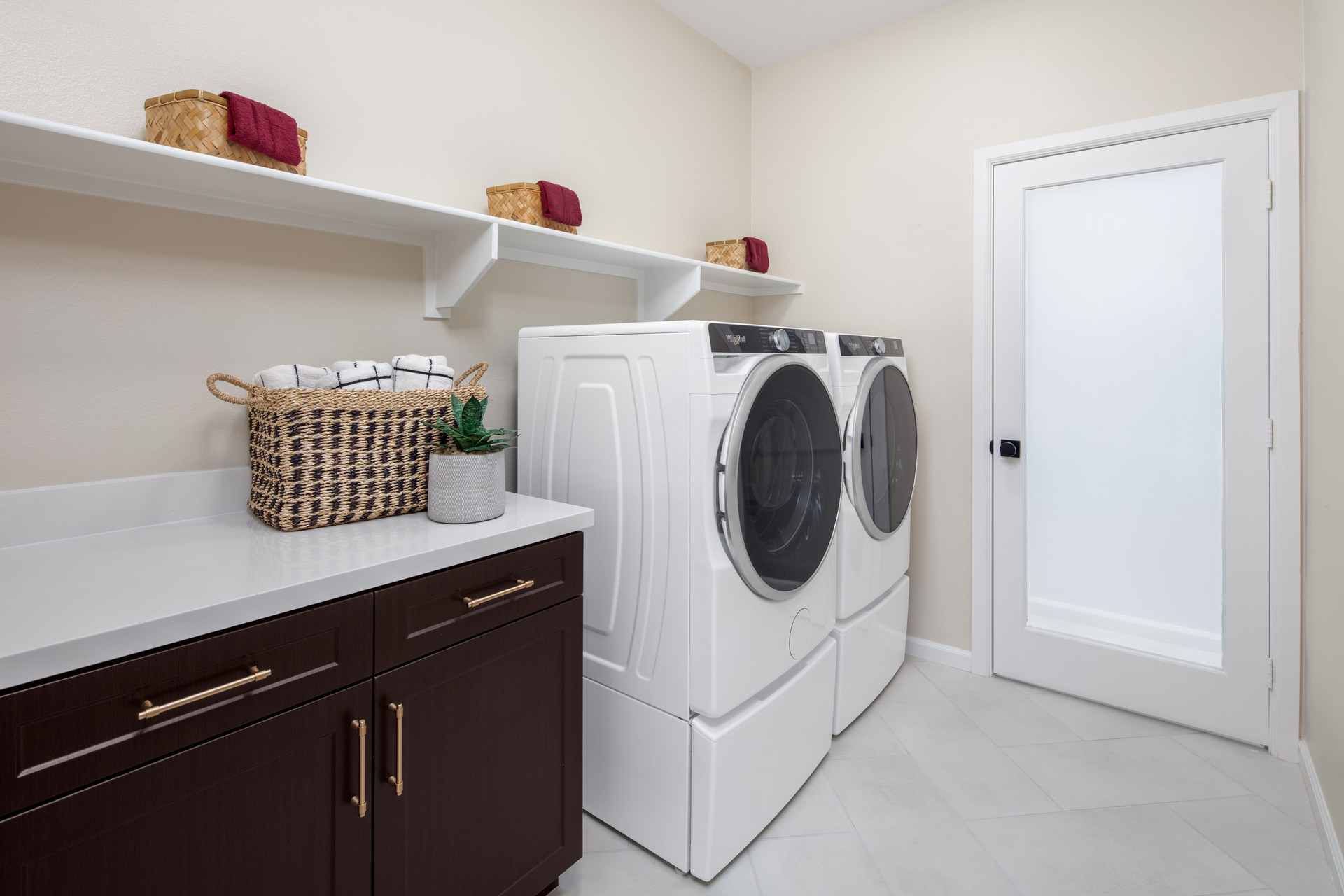 laundry room with neutral floors and storage