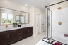 primary bathroom with neutral floors and white countertops