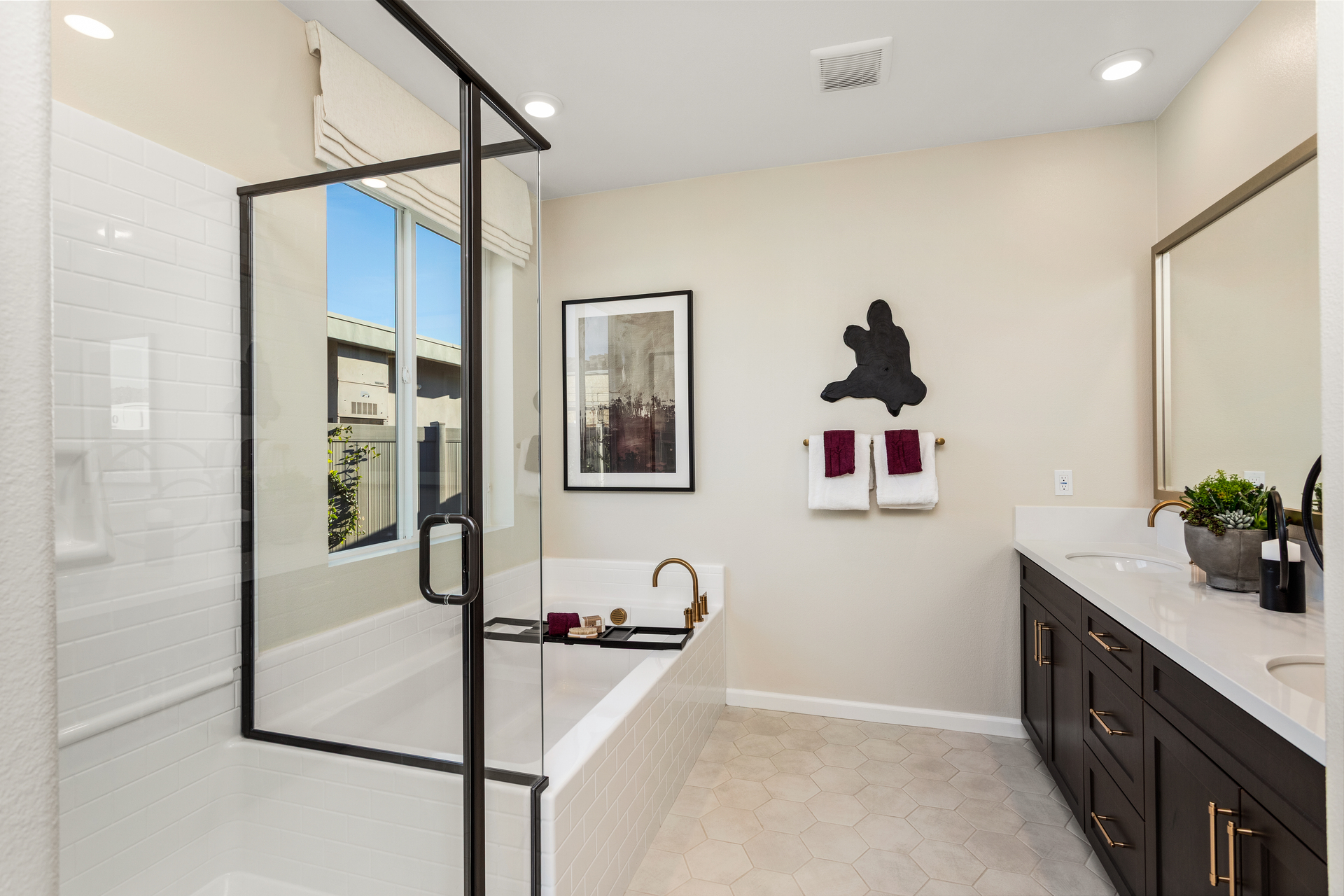 primary bathroom with neutral floors and large window
