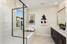 primary bathroom with neutral floors and large window