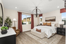 primary bedroom with neutral floors and large windows