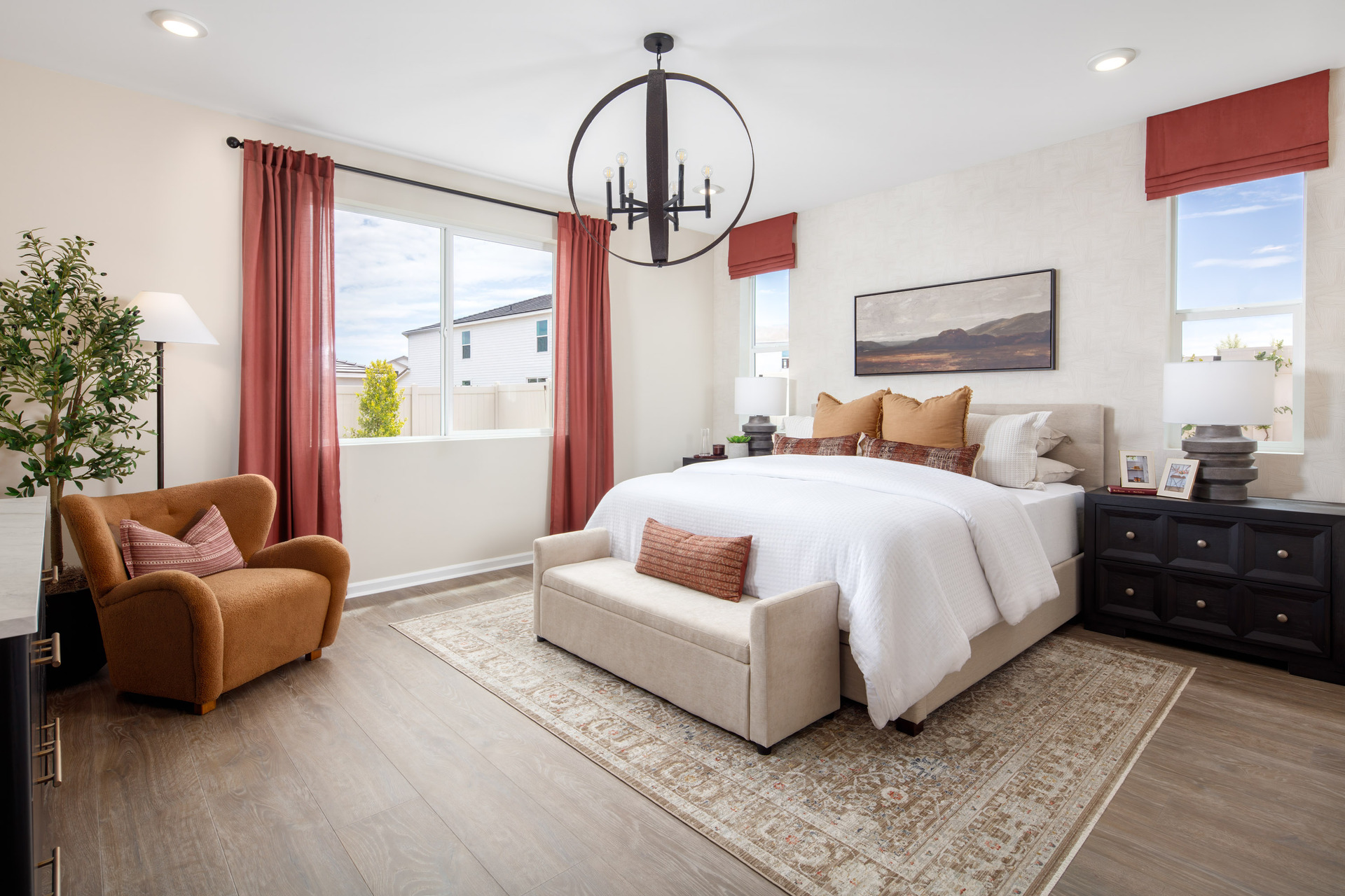 primary bedroom with neutral floors and large windows