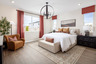 primary bedroom with neutral floors and large windows