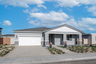 exterior of single-story home with white garage and desert landscaping