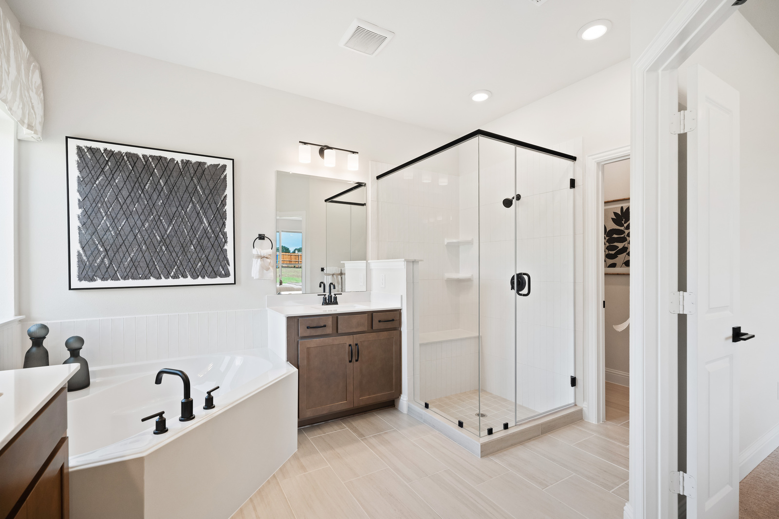 primary bathroom with bathtub and walk-in shower